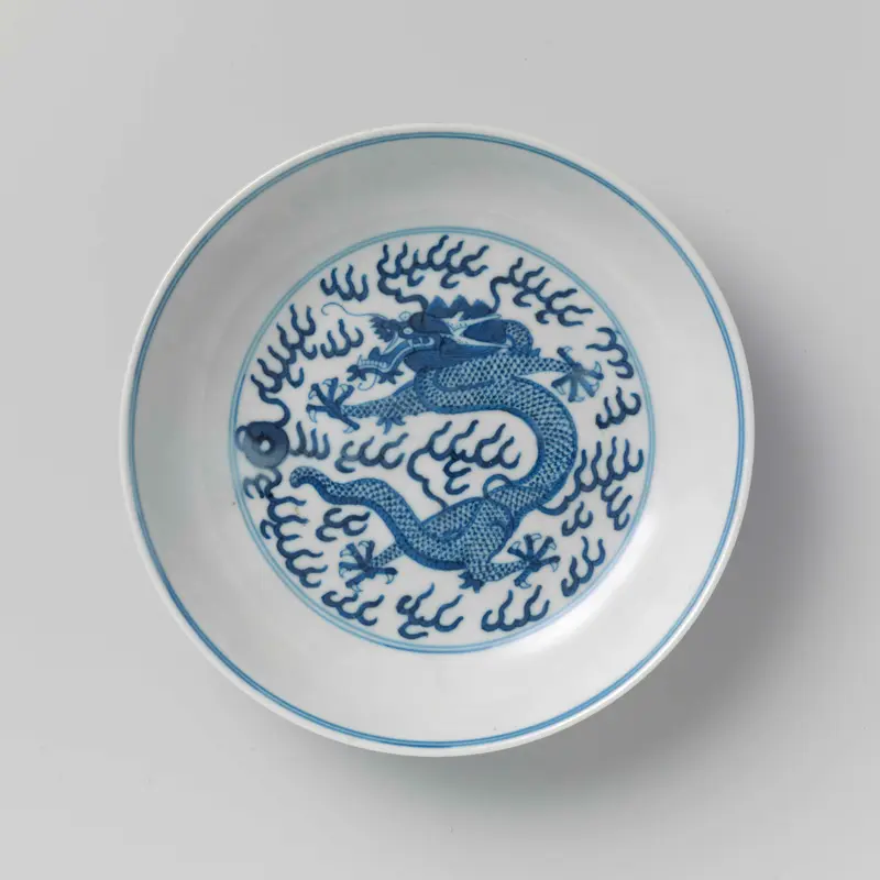 Porcelain saucer-dish featuring pearl chasing dragons by Unknown Artist