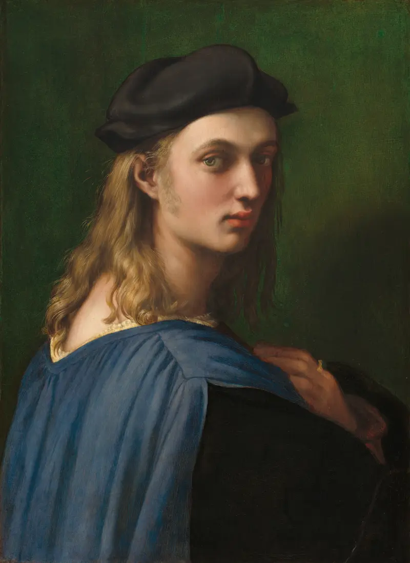 A young man with long blond hair, wearing a black cap and blue garment, looks over his left shoulder with his right hand on his chest against a green background.