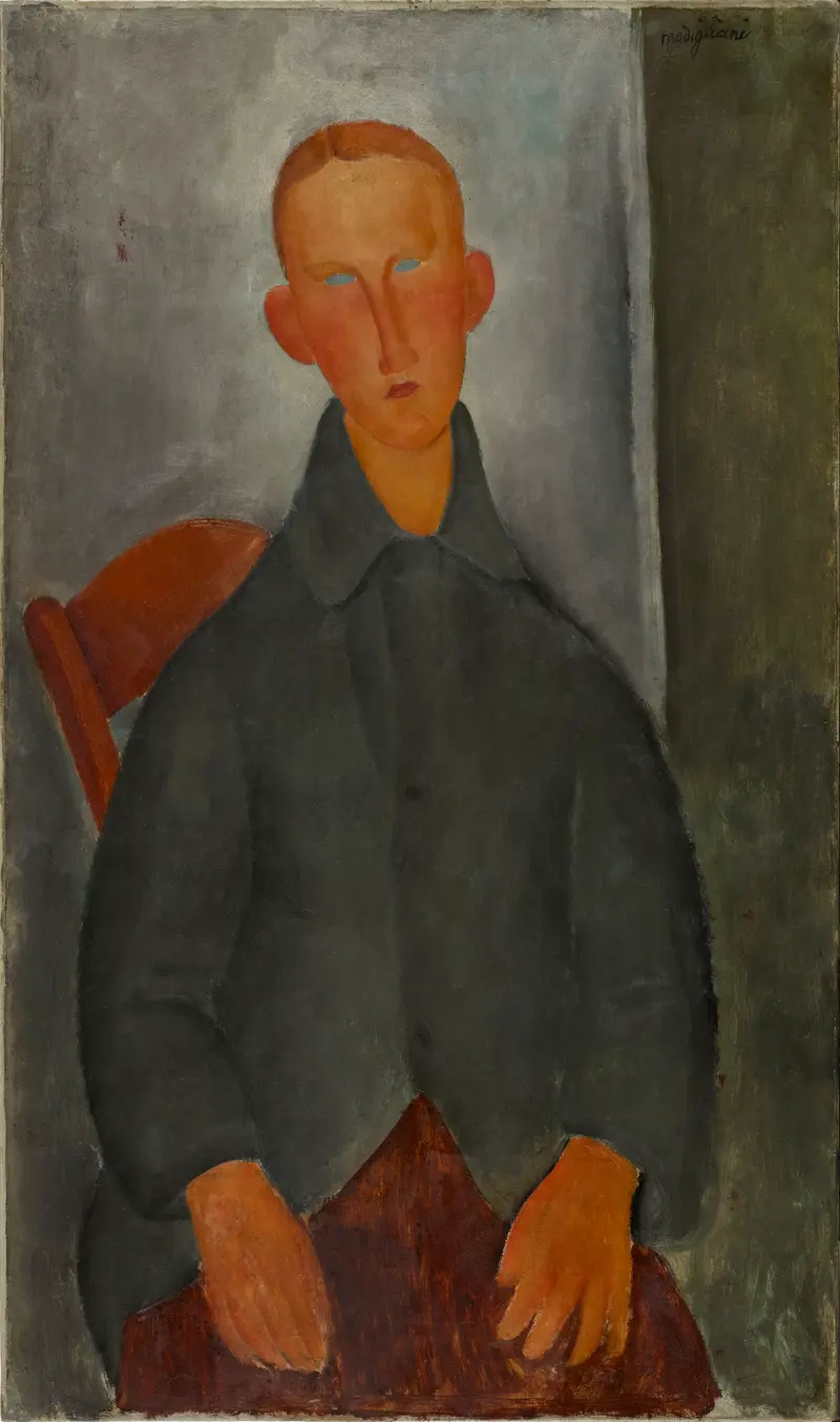 A red-haired boy seated, gazing directly at the viewer in a portrait by Amedeo Modigliani.