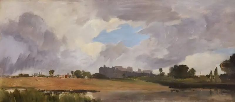 A landscape showing a riverbank and meadow with red-roofed buildings, dark trees, reflective water, and a cloudy sky with a patch of blue.