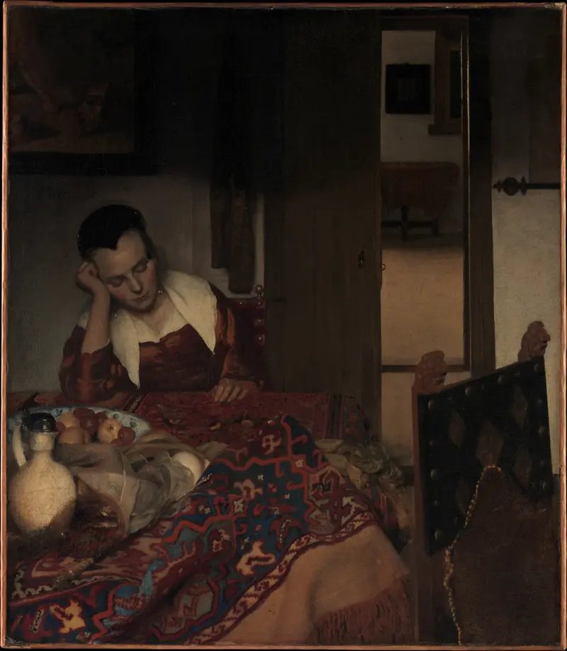 A young woman in a deep red dress sleeps with her head resting on her hand at a table covered with a patterned carpet, beside a Chinese bowl of fruit, a white ewer, and a tipped glass.