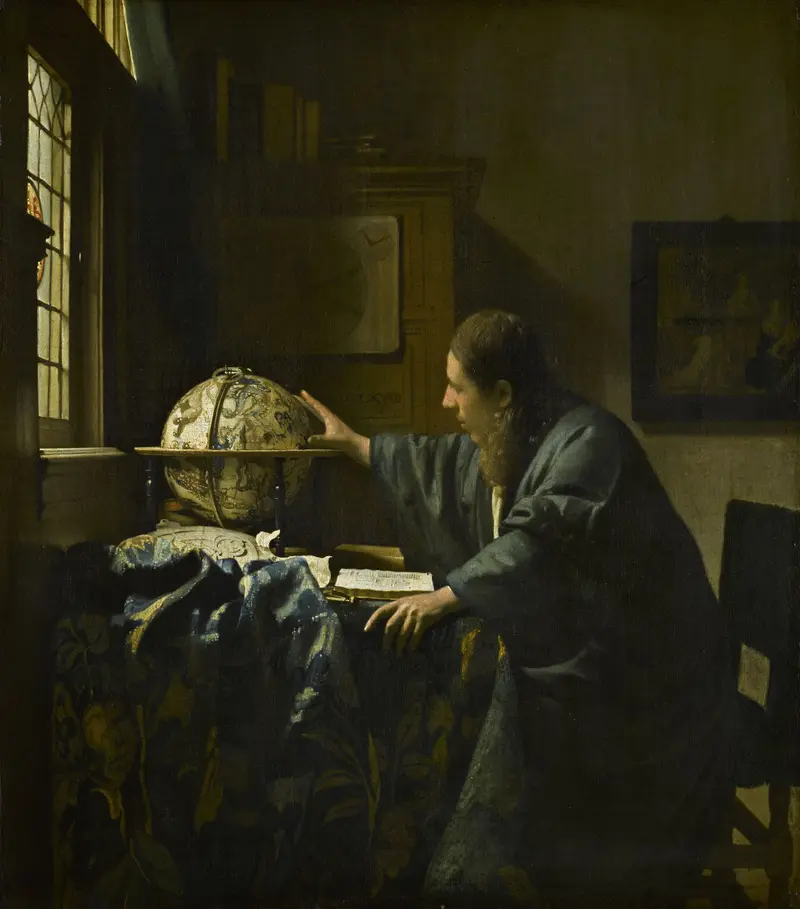 A man in a blue robe sits at a table with a celestial globe and an open book, illuminated by light from a window.