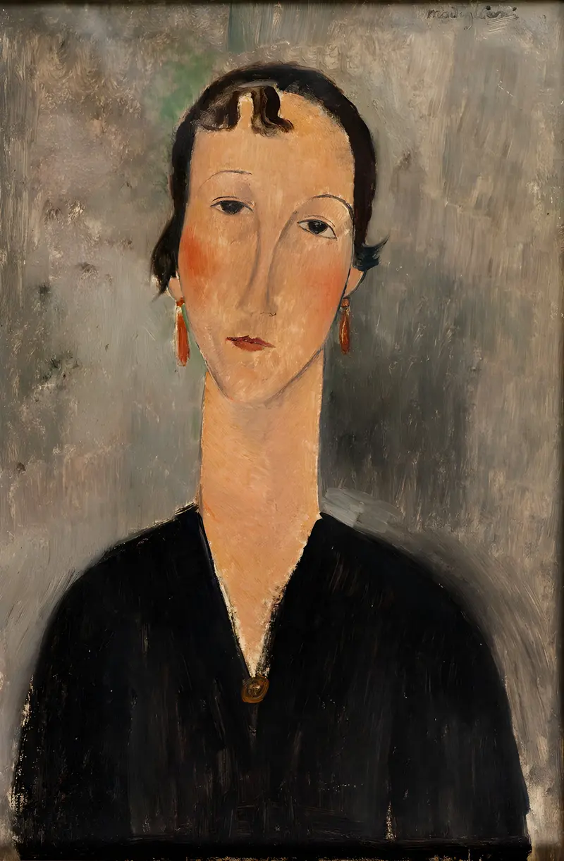 Portrait of a woman with elongated features wearing orange-red earrings, dark hair with a curl on her forehead, against a softly brushed neutral background.