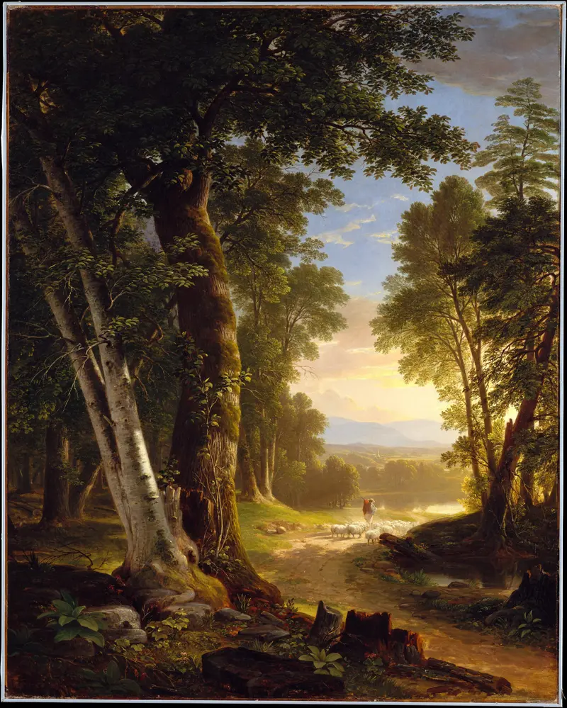 A sunlit forest path framed by large beech trees shows a shepherd in red guiding a flock of sheep toward a water’s edge amid dense foliage and distant hills.