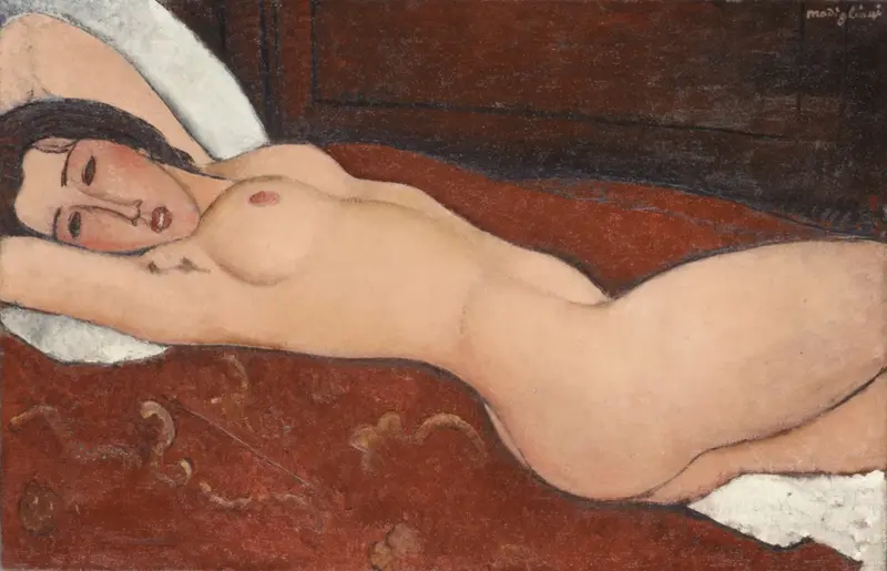 A nude woman reclines diagonally on a red surface with dark hair fanned out, one arm behind her head, and her face turned toward the viewer.