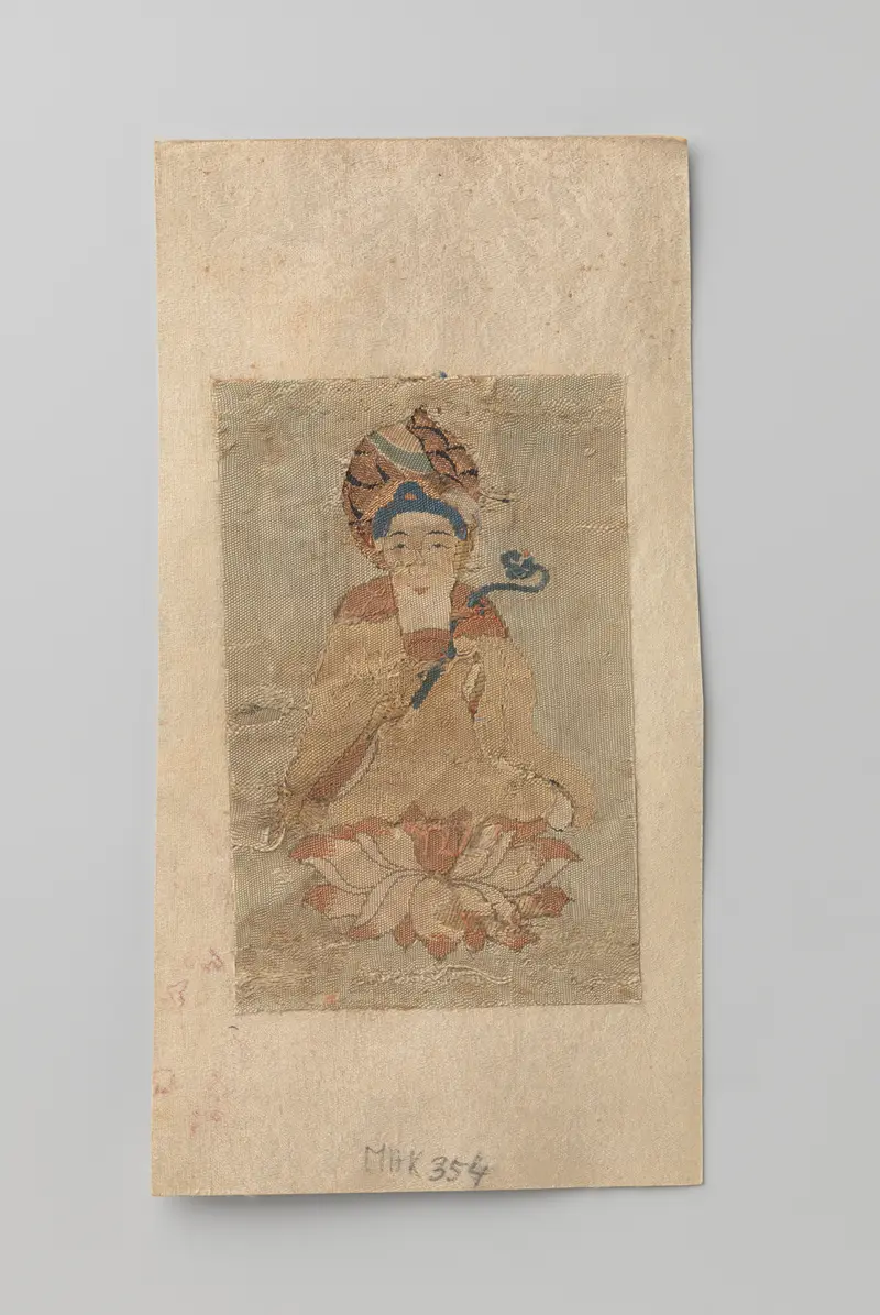 Buddhist tapestry by Unknown Artist depicting a seated Buddha with ruyi on a lotus