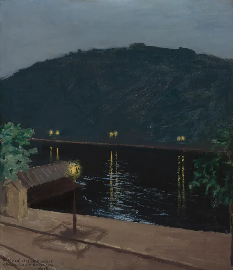 A solitary lamp glows at the riverbank, casting yellow light on the dark waters of the Danube in Budapest.