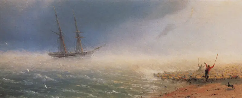 A flock of sheep is driven towards the sea by two herders amidst mist and spray.