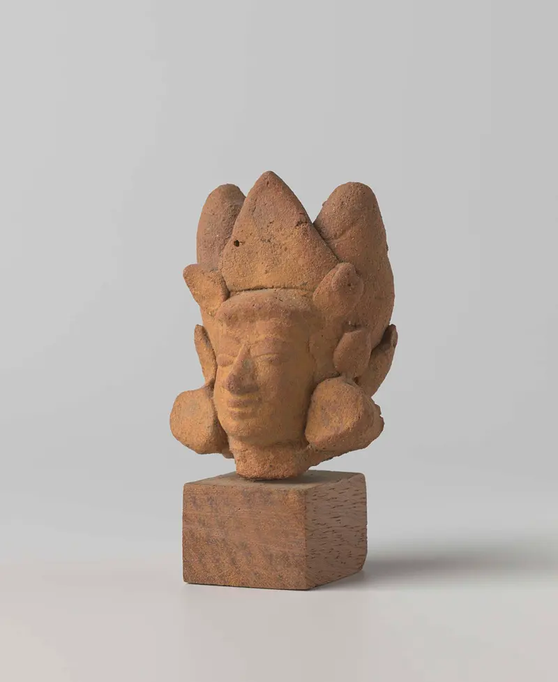 Terracotta sculpture of a head by Unknown Artist, showcasing intricate features and expression.
