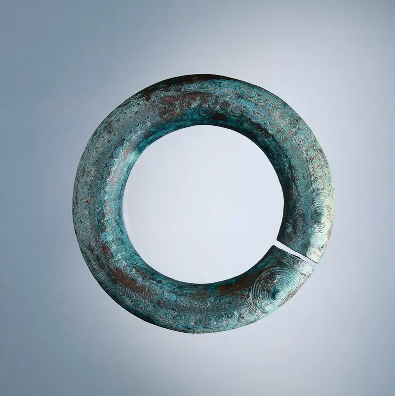 Bronze armband by unknown artist, featuring intricate patterns and ancient design.