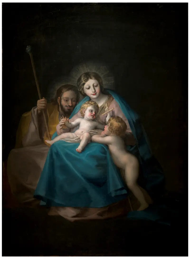 A depiction of the Holy Family with Virgin Mary, infant Christ, and Joseph in a warm domestic scene.
