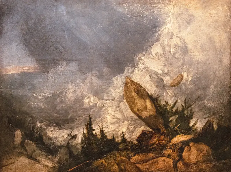 A jagged boulder and rocky slope with coniferous trees beneath a snow-covered mountain and turbulent grey-blue sky.