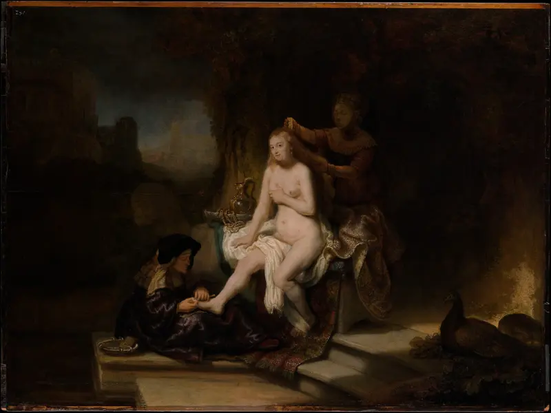 A nude woman sits illuminated at the center while two attendants wash and groom her, surrounded by a richly patterned carpet and dark background.