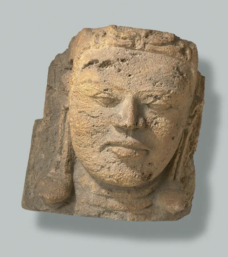 Stone sculpture of a head from Candi Bima by Unknown Artist