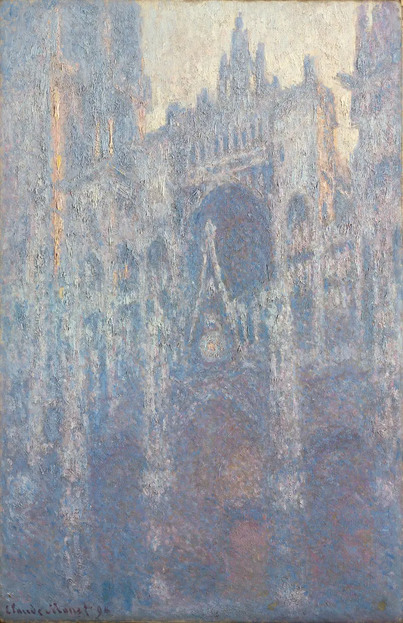 A close-up view of Rouen Cathedral's central portal bathed in pale morning light, showing textured stonework and soft colors.
