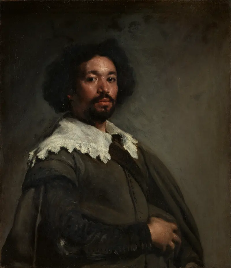 A man with dark complexion and curly hair wears a brown garment with a white lace collar, standing three-quarters turned against a smoky grey-brown background.