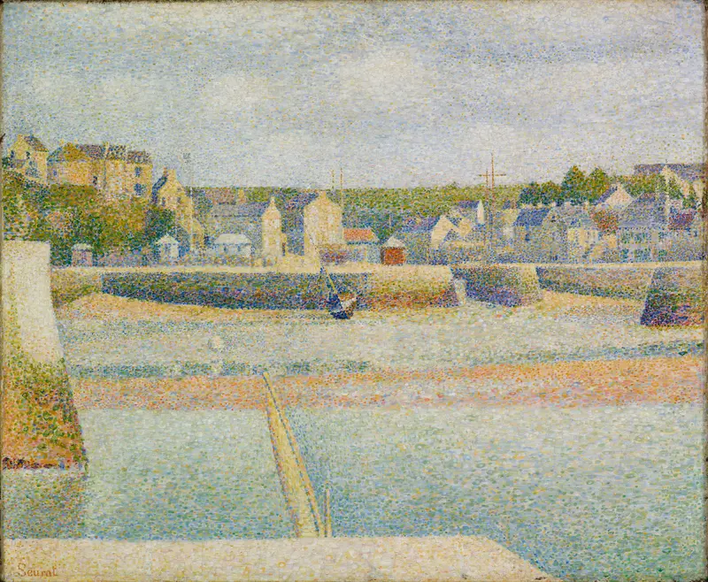 A harbor at low tide shows boats resting on exposed sand, a stone pier, a village with colorful houses, and green trees under a pale blue sky.