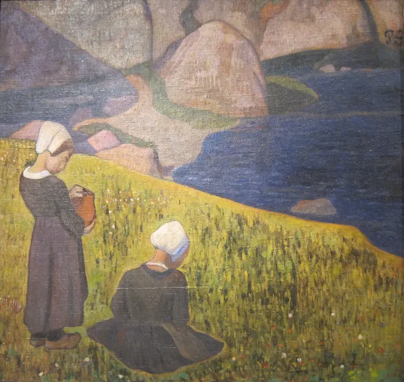 A group of Breton women in traditional attire gathered in a field overlooking the sea.