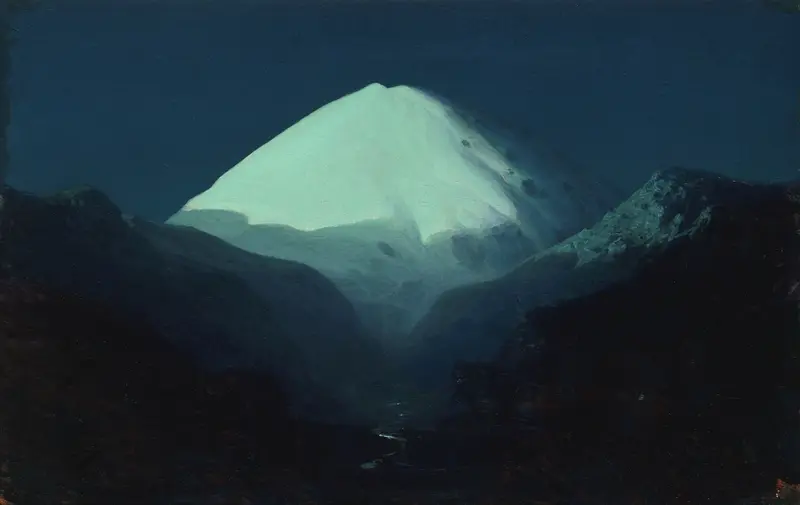 A luminous mountain peak rises from darkness against a deep blue sky, its icy summit glowing while shadows gather below.
