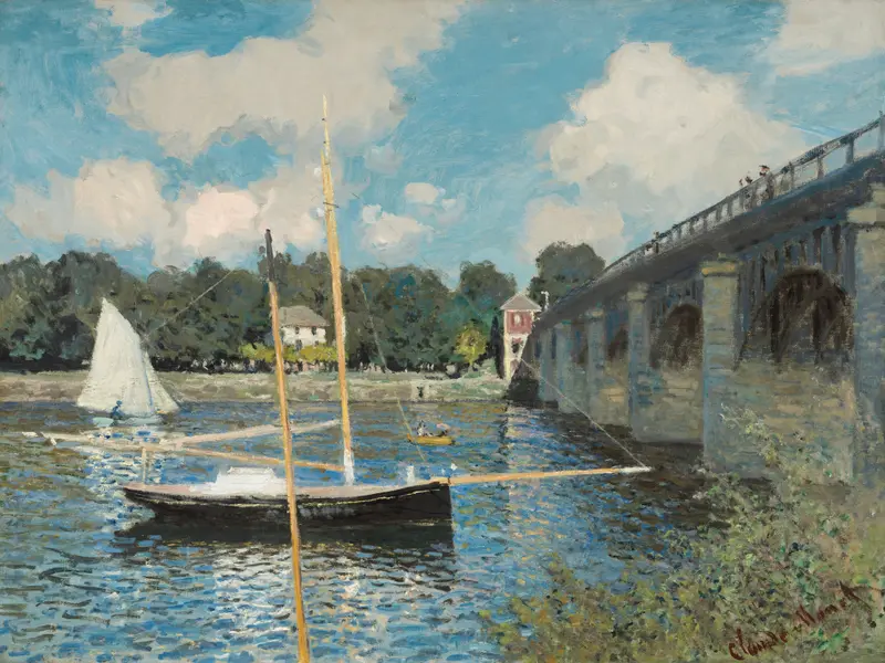 A sailboat with a white sail glides on shimmering water near a stone bridge with small figures, trees, and a red building by the riverbank.