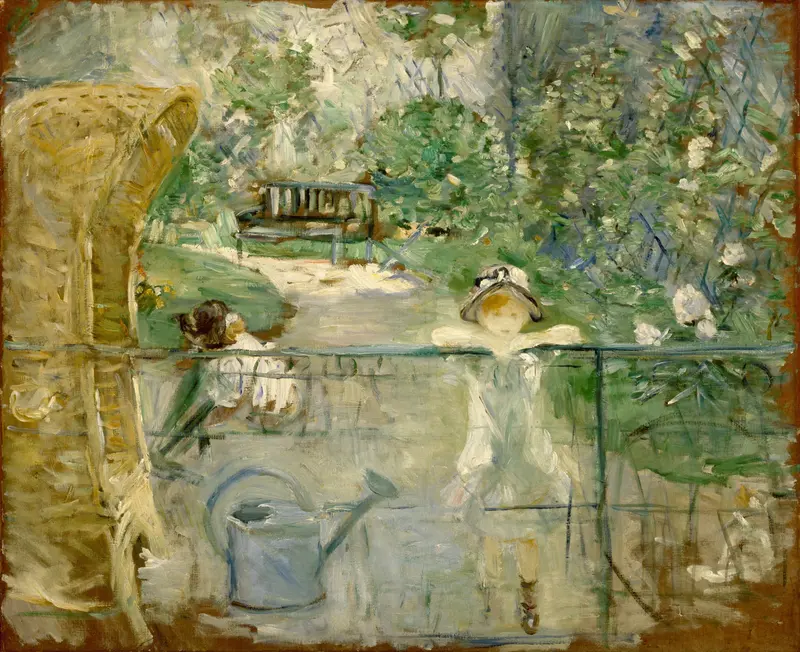 A young girl in a pale dress leans over a gate beside a wicker basket chair in a lush garden.