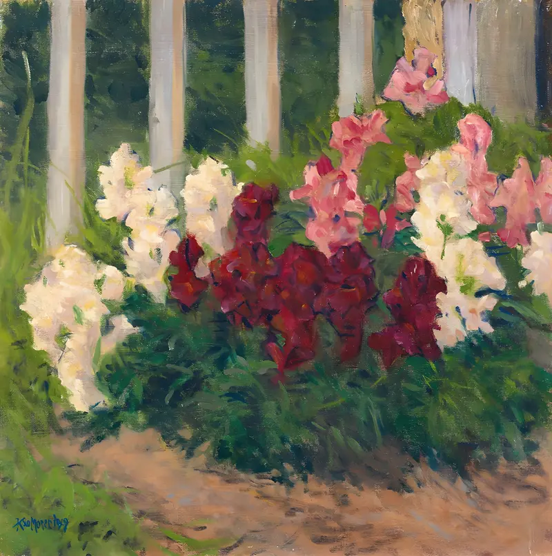 A vibrant still life featuring flowers before a garden fence.