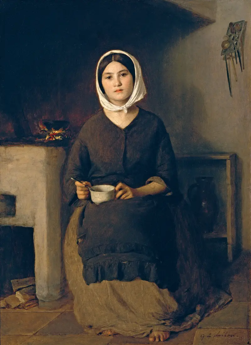A seated woman in a rustic kitchen setting.