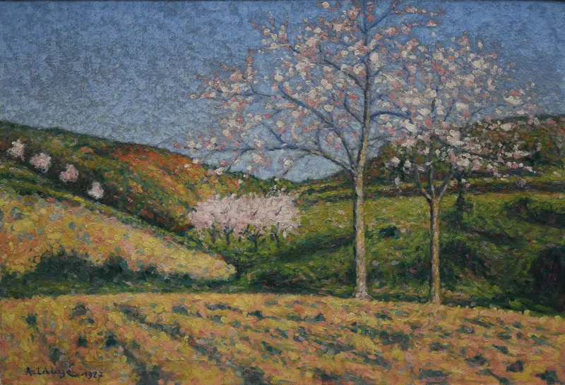 Two almond trees with pale pink and white blossoms stand in a vibrant landscape under a cool blue sky.