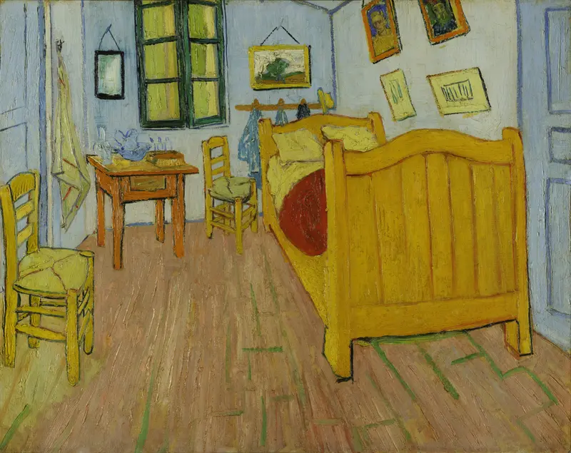 A brightly colored room with a yellow wooden bed, two yellow chairs, a small table with a pitcher and basin, and an open window with green shutters.