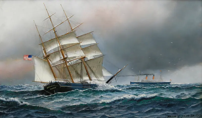 A ship with a black hull and white decks cuts through the water, flags snapping in the wind against a pale sky.