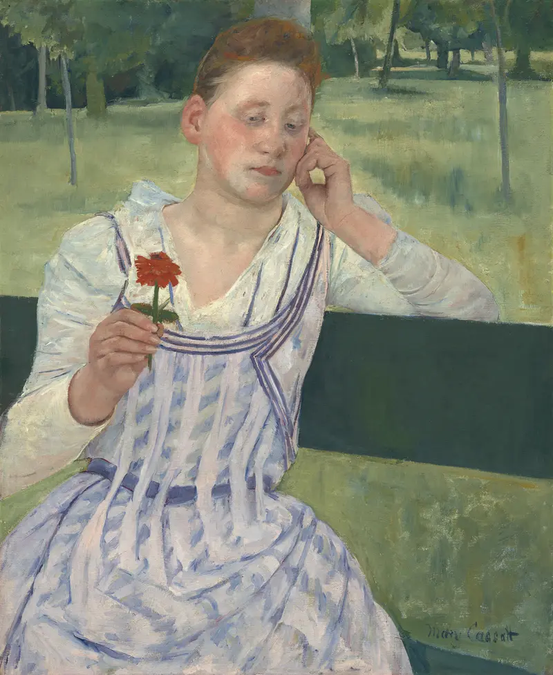 A young woman contemplates a red zinnia in a serene moment.
