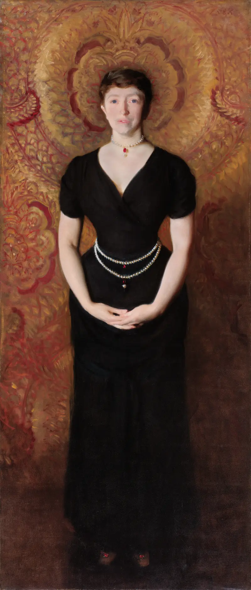 A woman in a dark dress with pearl and red-gold jewelry stands against a richly patterned golden backdrop with floral motifs.