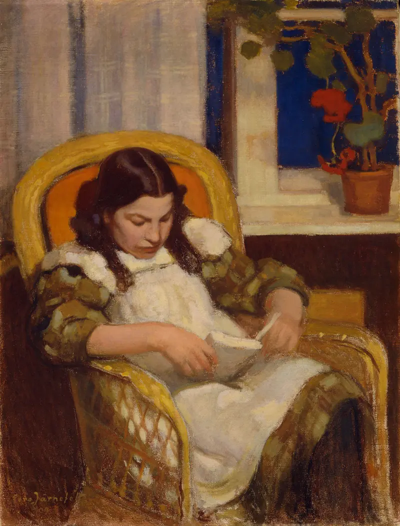 A young girl deeply engrossed in reading a book.