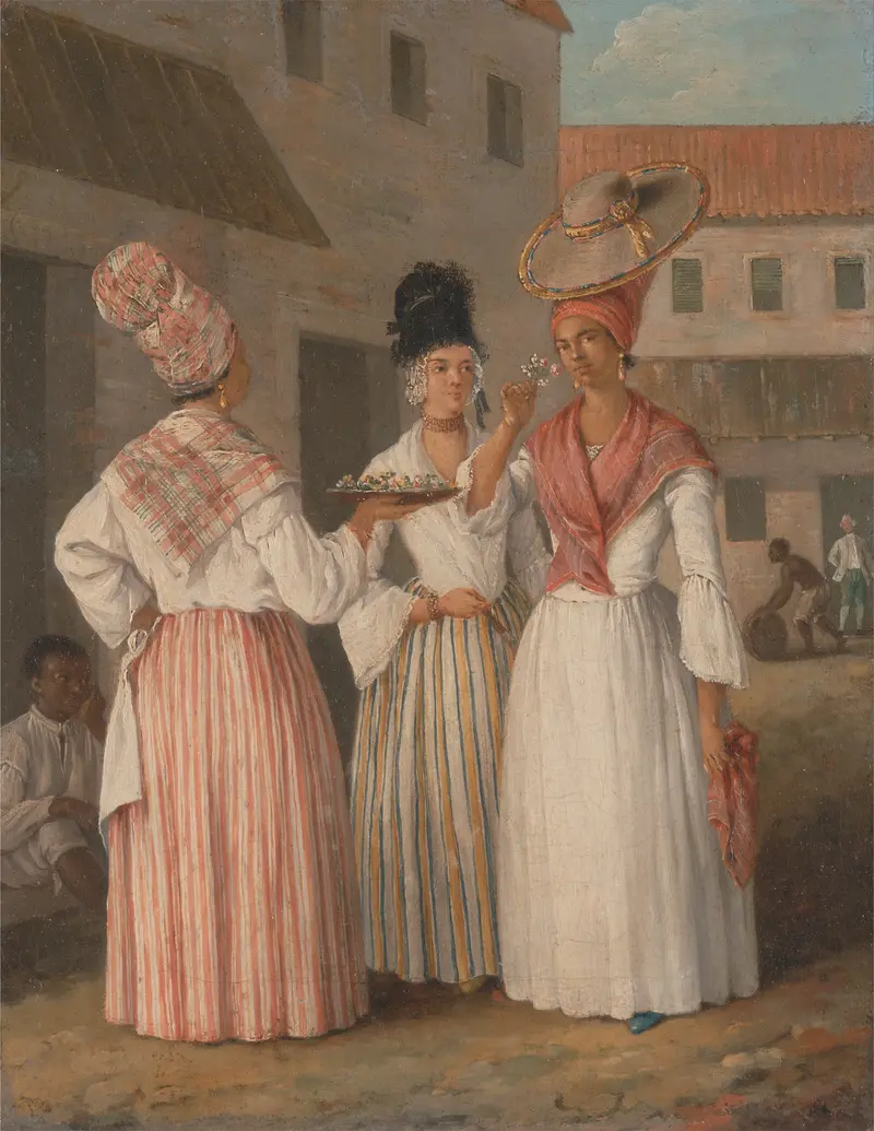 Three women in vibrant dresses stand confidently in an open courtyard, showcasing their fashion and poise.