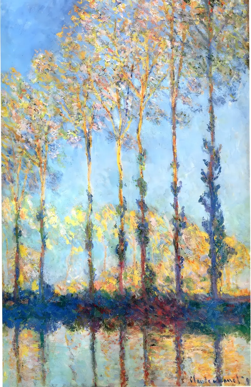 Tall poplar trees with colorful autumn foliage stand vertically above the calm Epte River, reflecting in the water beneath a soft blue sky.