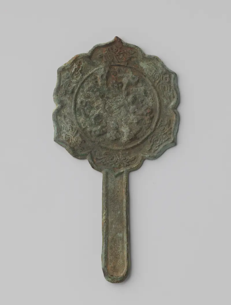 Bronze mirror with intricate plant motifs by Unknown Artist