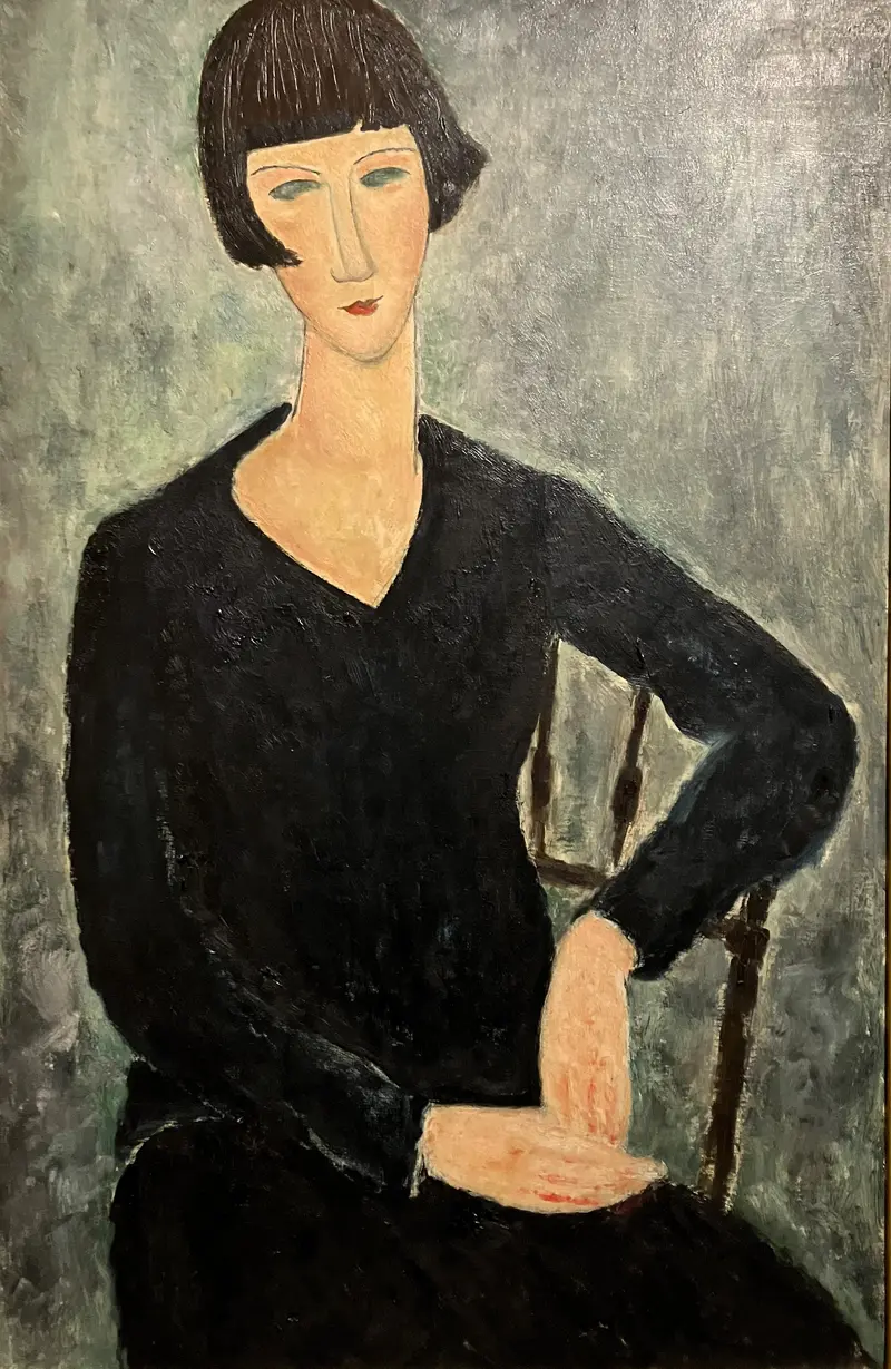 A woman seated in a blue dress with an elongated neck and mask-like face, painted by Amedeo Modigliani.