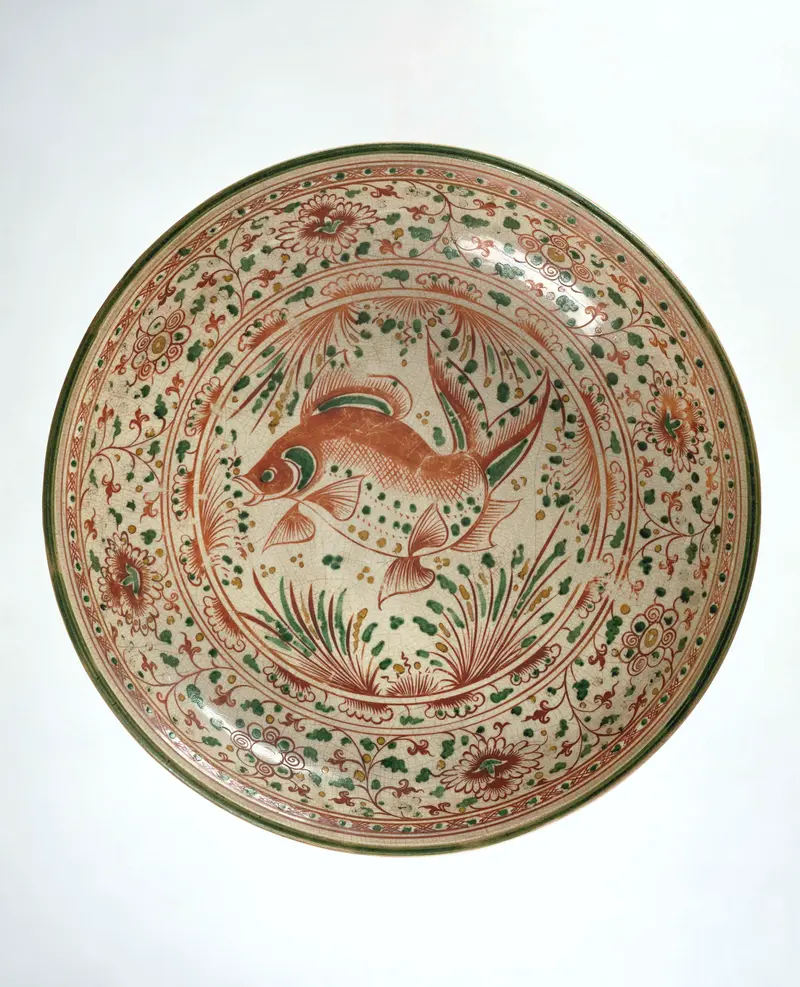 Ceramic saucer-dish featuring a fish and floral scrolls by Unknown Artist