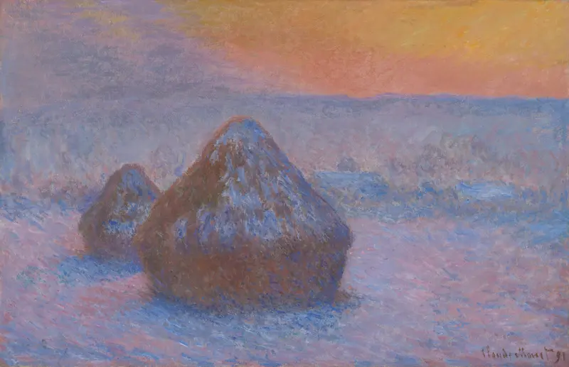 Two conical wheat stacks rise from a snow-covered field beneath a colorful sunset sky with purplish hills in the background.
