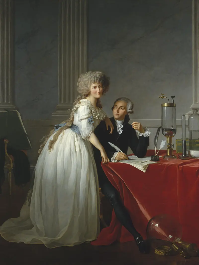 Marie Anne Lavoisier stands beside seated Antoine Laurent Lavoisier at a red velvet-covered table with scientific instruments and documents.