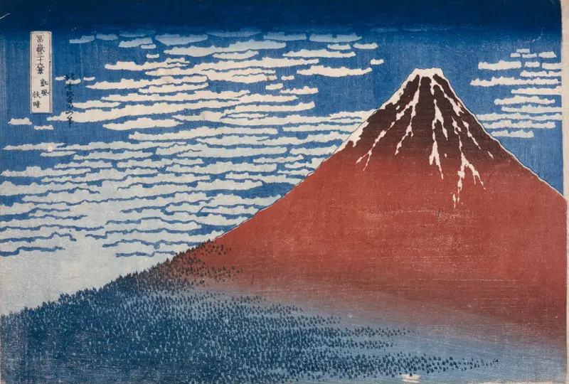 A triangular red and blue mountain with white snow streaks under a sky filled with soft horizontal clouds.