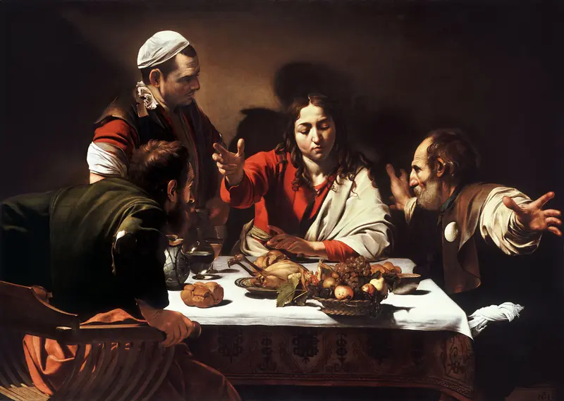 A beardless man in red and white blesses bread at a table while two men react with astonishment against a dark background.