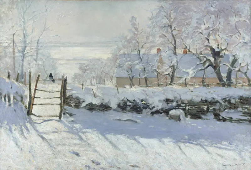 A black magpie perched on a wooden gate surrounded by snow-covered ground, trees, and a wattle fence under a pale winter sky.