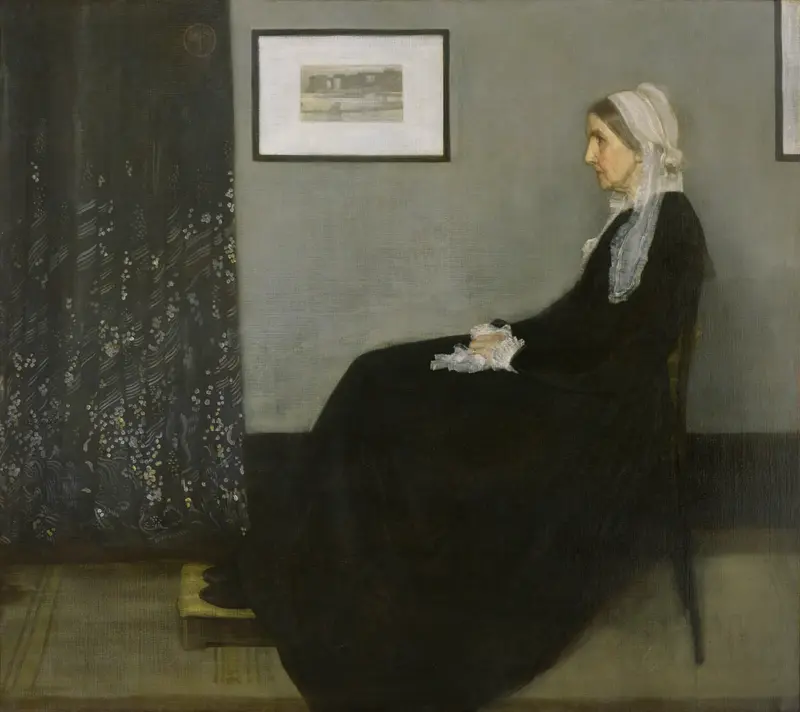 A seated elderly woman in profile, hands folded, wearing a black dress and white lace cap against a muted grey wall.